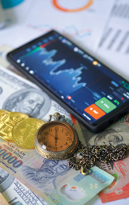 Business and Financial Concept. Multiple Currencies Banknote on graph with classic pocket watch and trading chart
